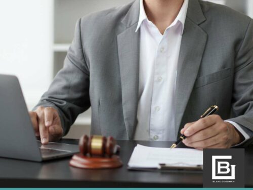 A lawyer working on a laptop and reviewing documents, offering advice on Bankruptcy for Seniors and financial recovery options