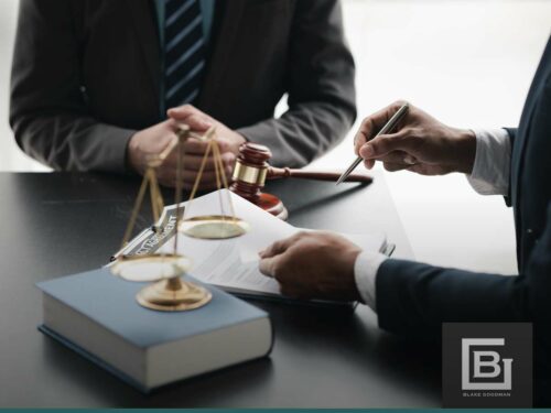 Lawyers discussing Chapter 7 bankruptcy paperwork with a gavel and scales of justice on the table