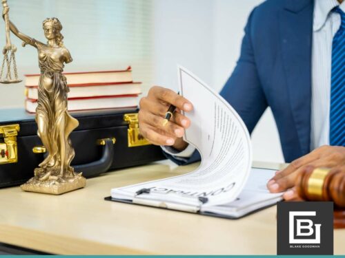 Attorney reviewing bankruptcy documents with a statue of Lady Justice, symbolizing legal proceedings